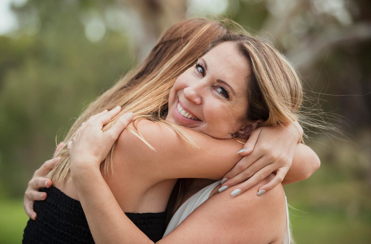 Image of two happy women hugging